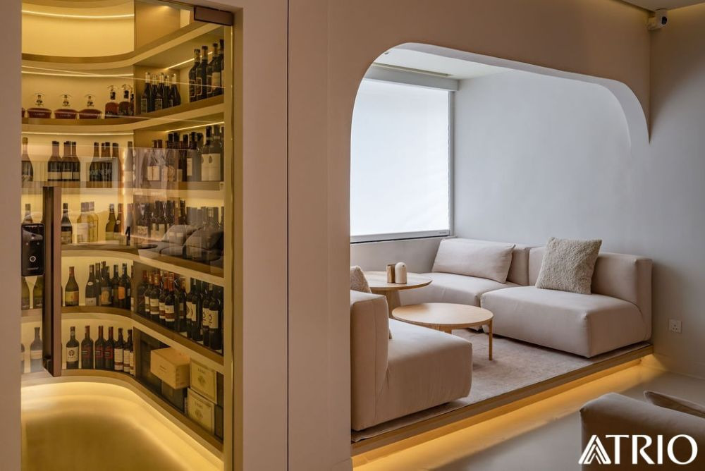 Arched bottle display and lounge seating in a modern bohemian bar